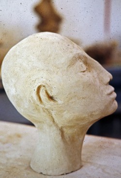 Handbuilt sculpture of Indian woman profile view. 