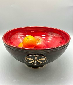 Large thrown bowl with Dragonfly. Black, brick, and snapdragon glaze’s overlapping