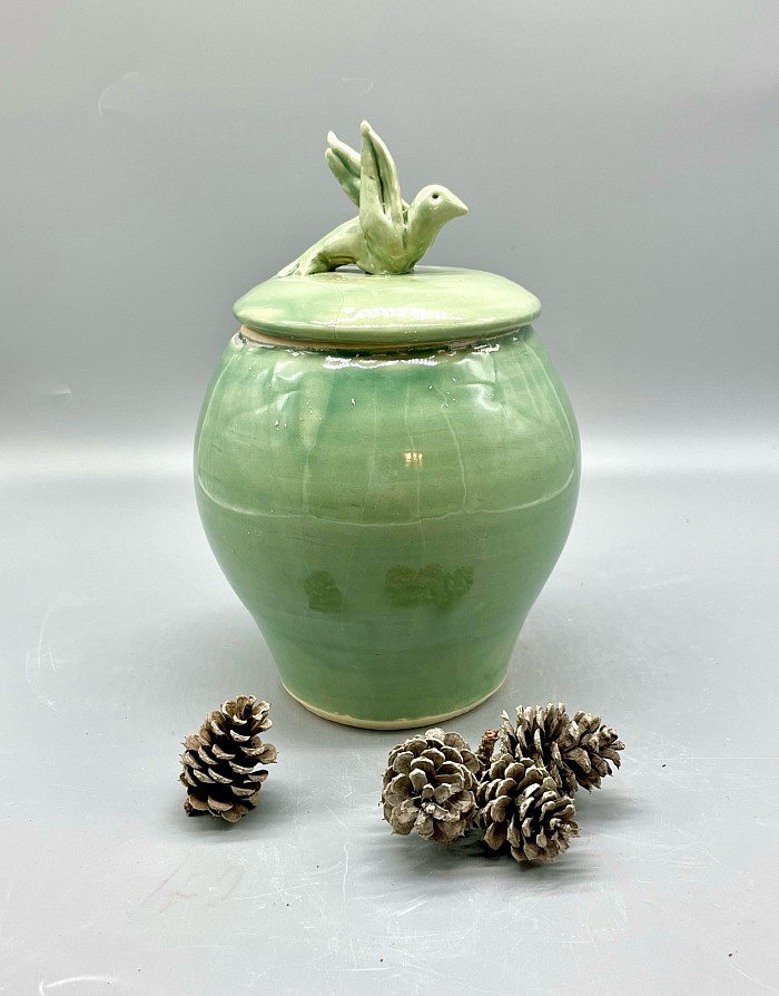 Porcelain jar with sculpted bird. Celadon green.